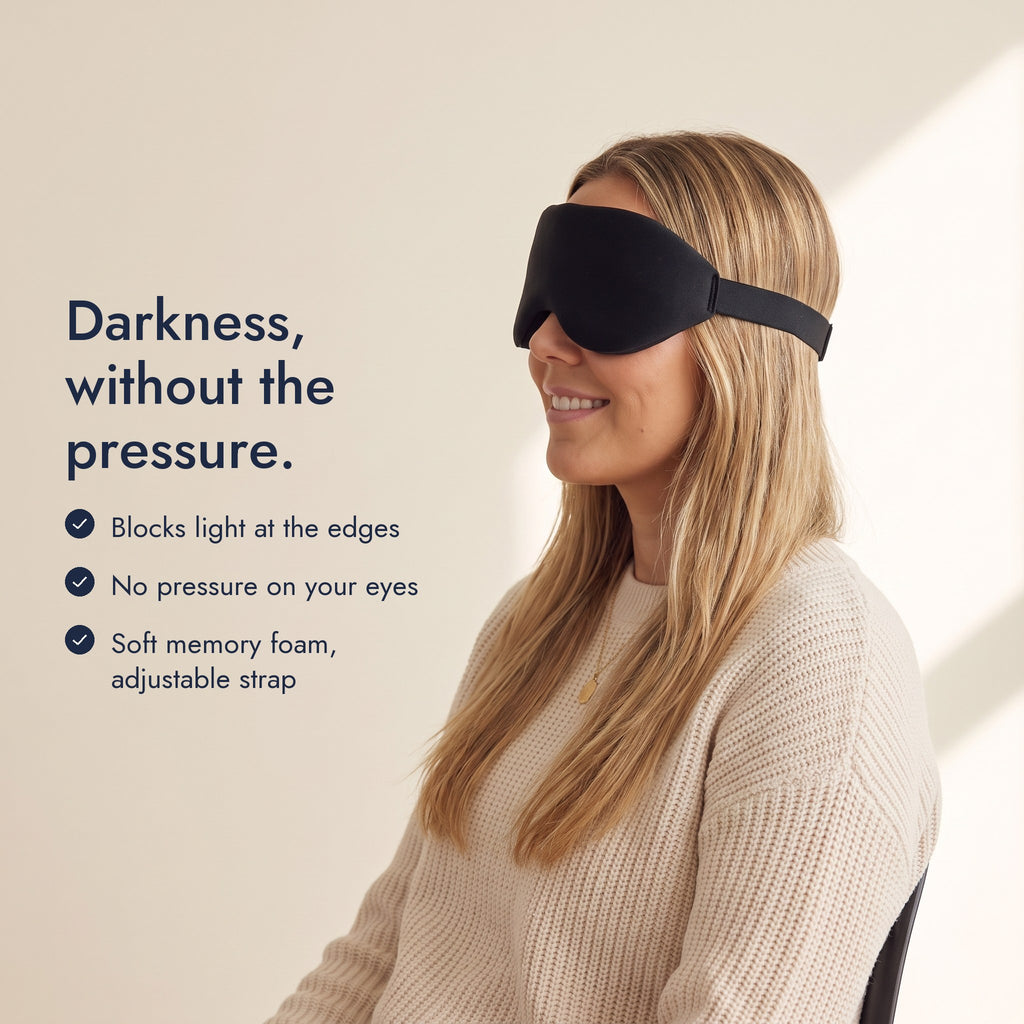 Woman wearing the Northdusk mask in profile. Darkness, without the pressure: blocks light at the edges, no pressure on your eyes, soft memory foam, adjustable strap.