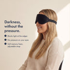 Woman wearing the Northdusk mask in profile. Darkness, without the pressure: blocks light at the edges, no pressure on your eyes, soft memory foam, adjustable strap.