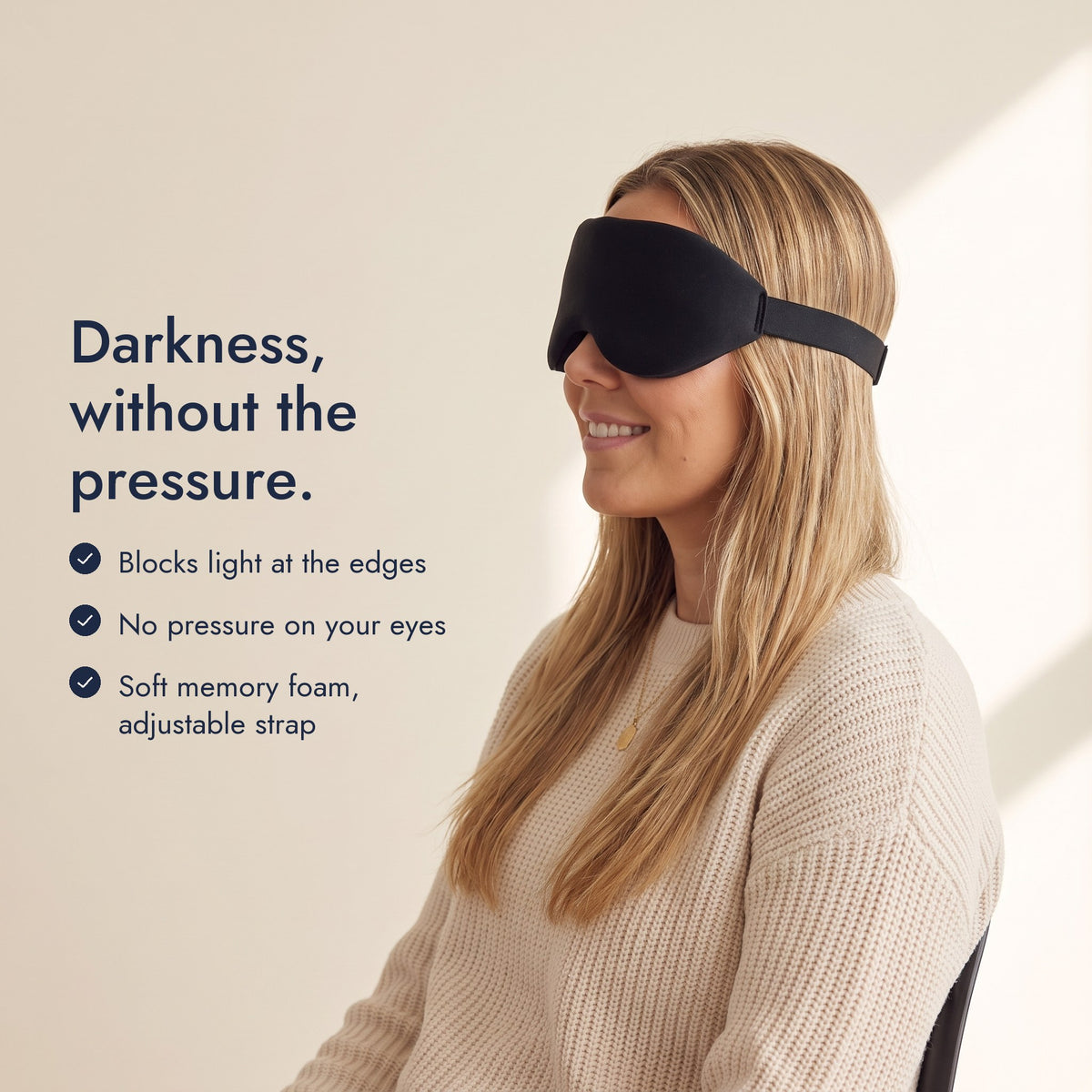 Woman wearing the Northdusk mask in profile. Darkness, without the pressure: blocks light at the edges, no pressure on your eyes, soft memory foam, adjustable strap.